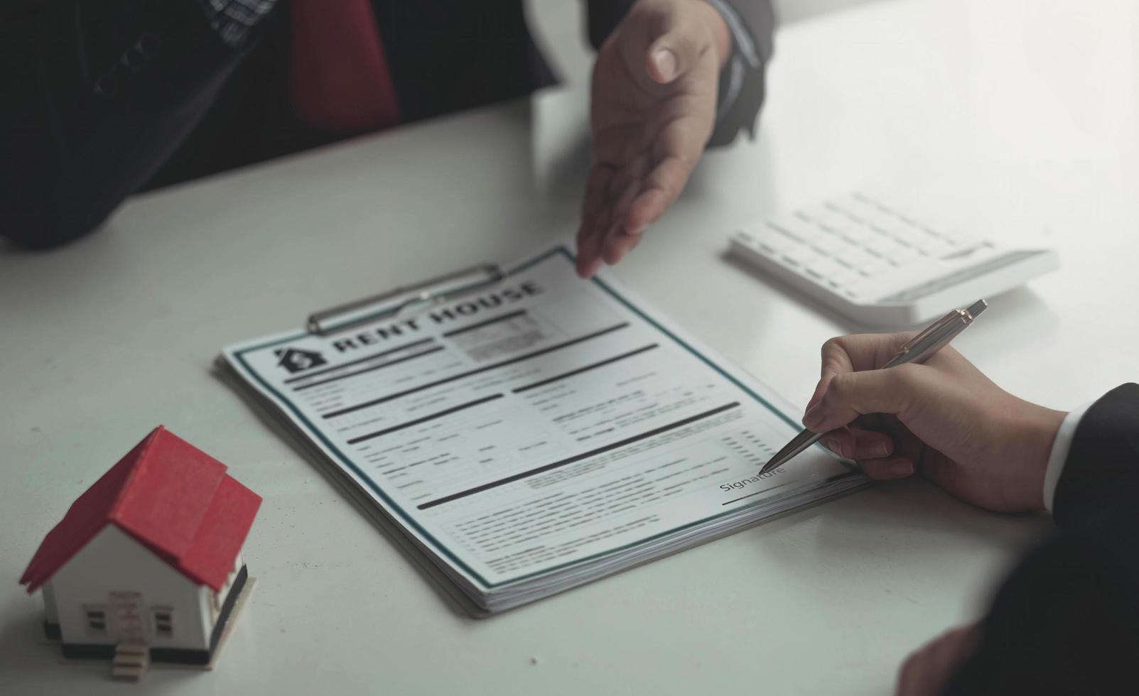 Salesmen are letting the male customers sign the sales contract, Asian women and men are doing business in the office, Business concept and contract signing photo