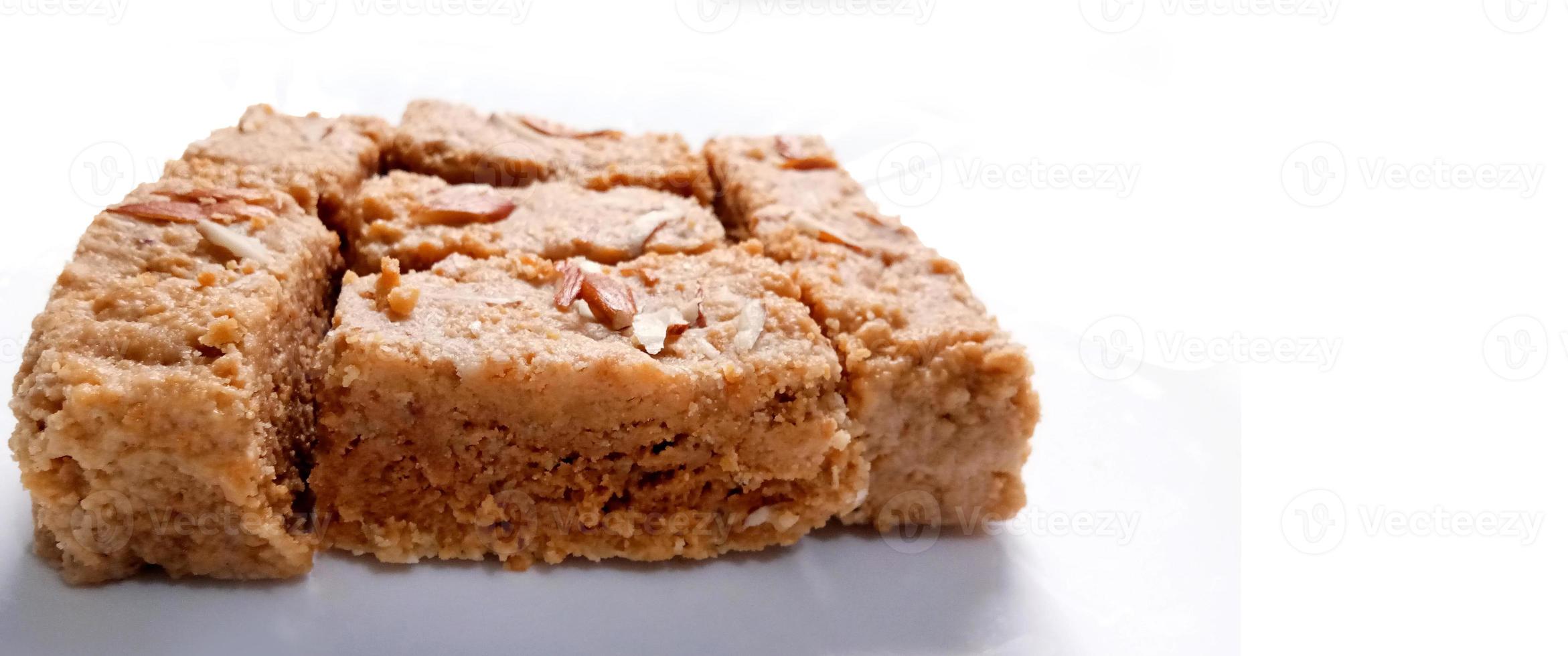 Indian Diwali Sweet Food Kalakand Also Know as Halwa or Mawa Kalakand is a Creamy Delicacy Made From Paneer or Cottage Cheese, The Dish Originated in Alwar, Rajasthan. Isolated on White Background photo