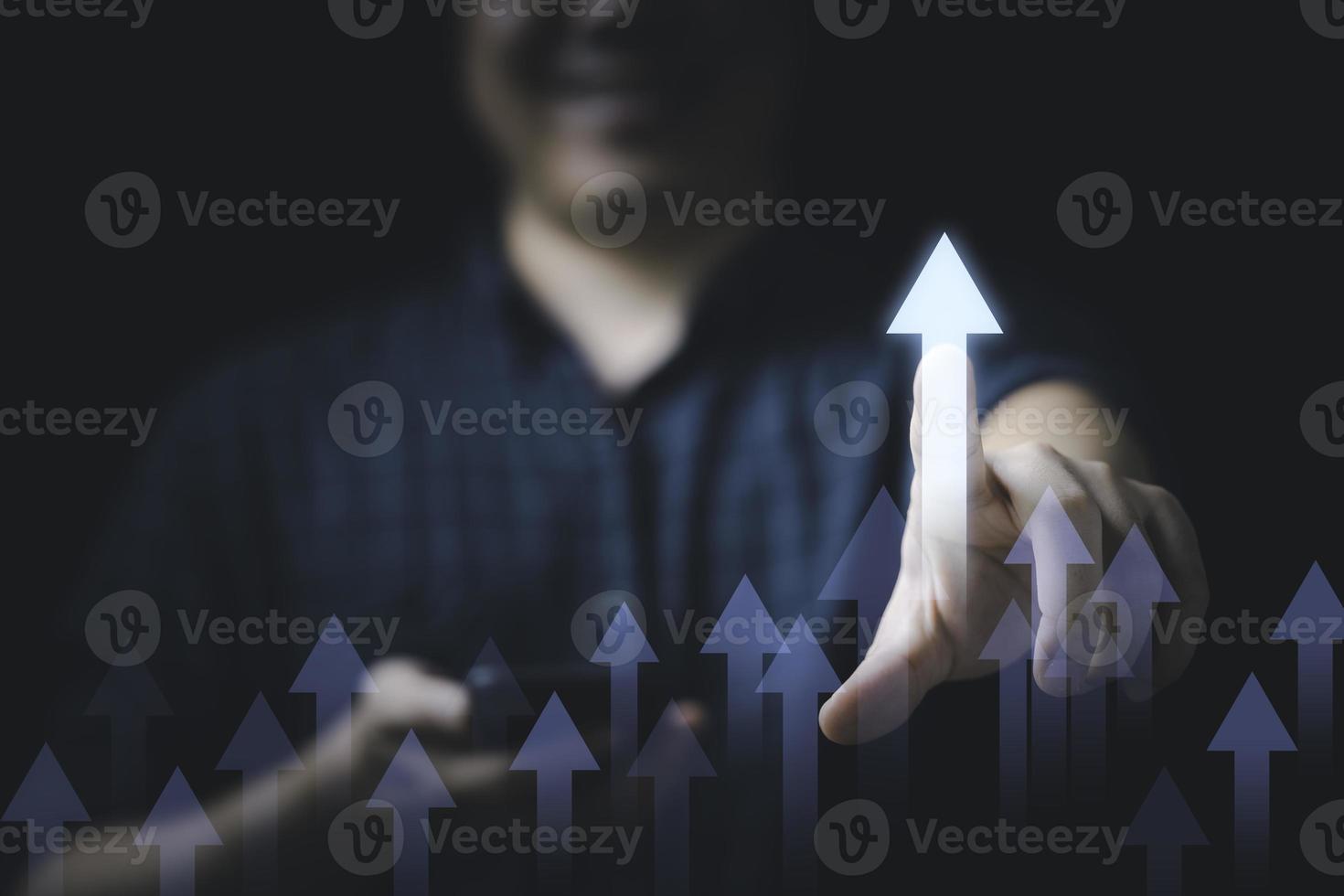 Businessman touching to glowing increasing arrow for business profit and investment growth concept. photo