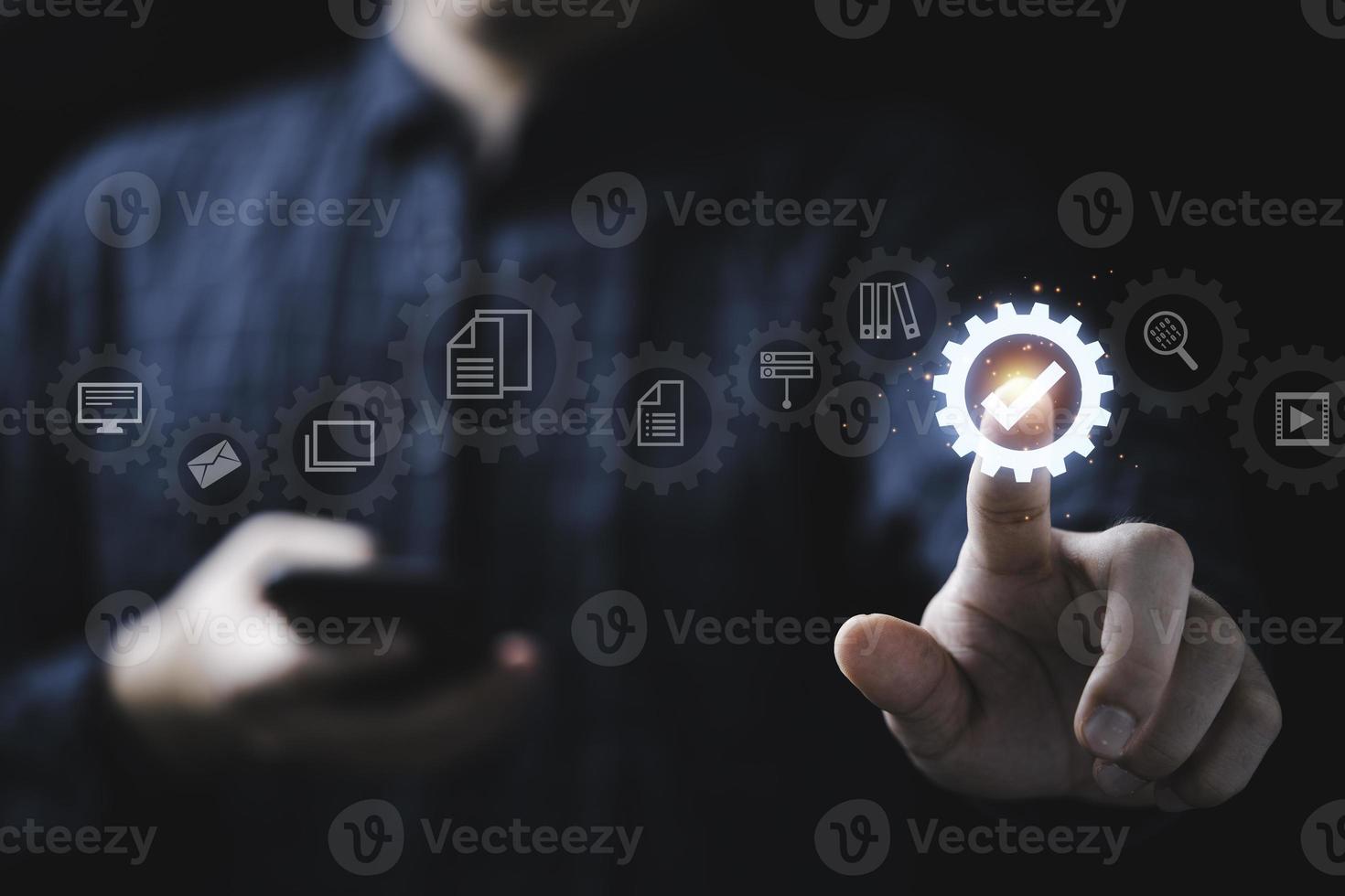 Businessman touching to correct sign or tick mark for approve document which inside of mechanical gear for online approve  paperless and quality assurance concept. photo