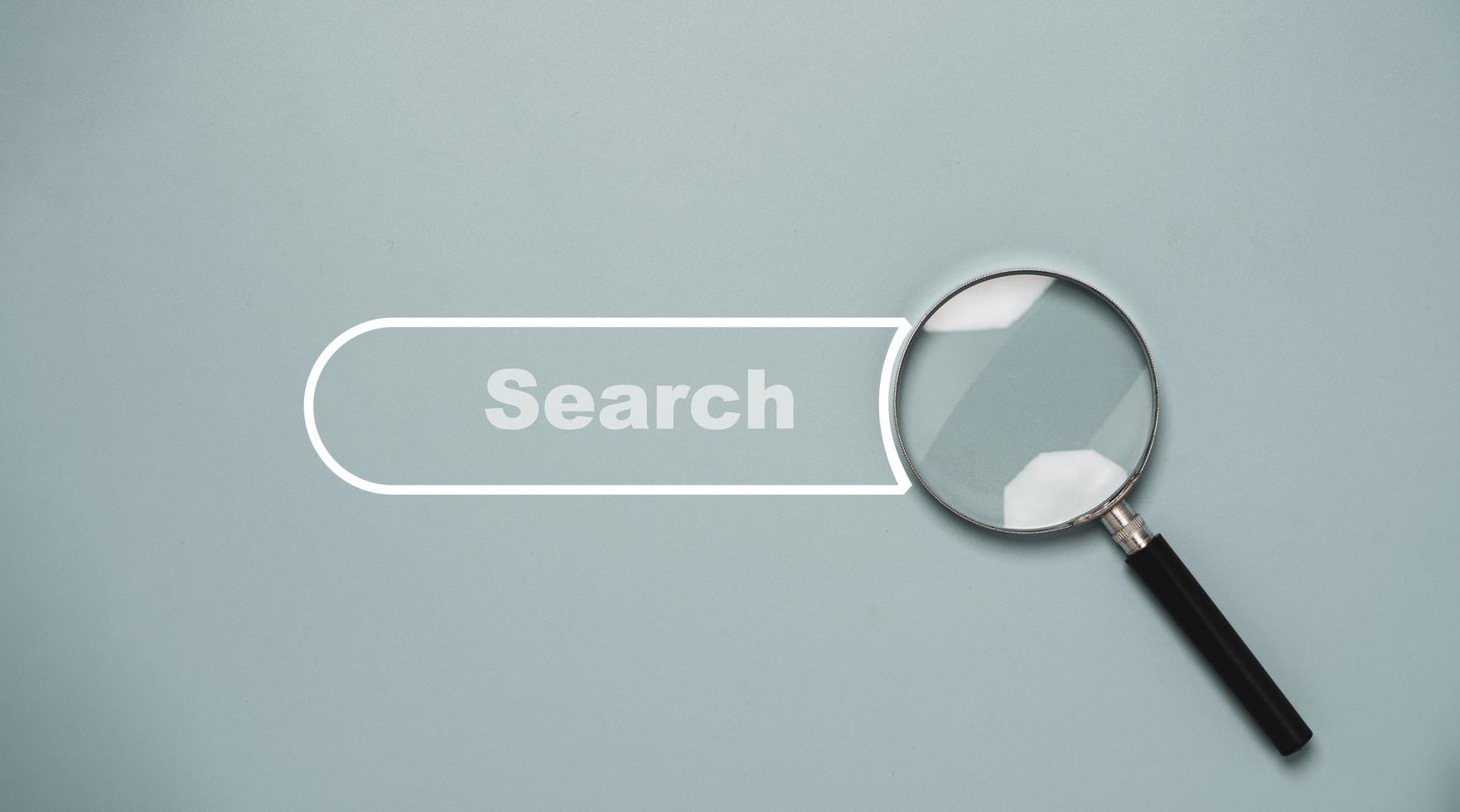 Magnifier glass with search bar icon for search engine optimisation or SEO concept. photo