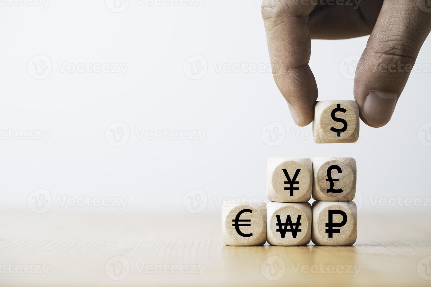 Hand putting use dollar sign on the main currency sign include yen euro and pound for trading forex and currency exchange concept. photo