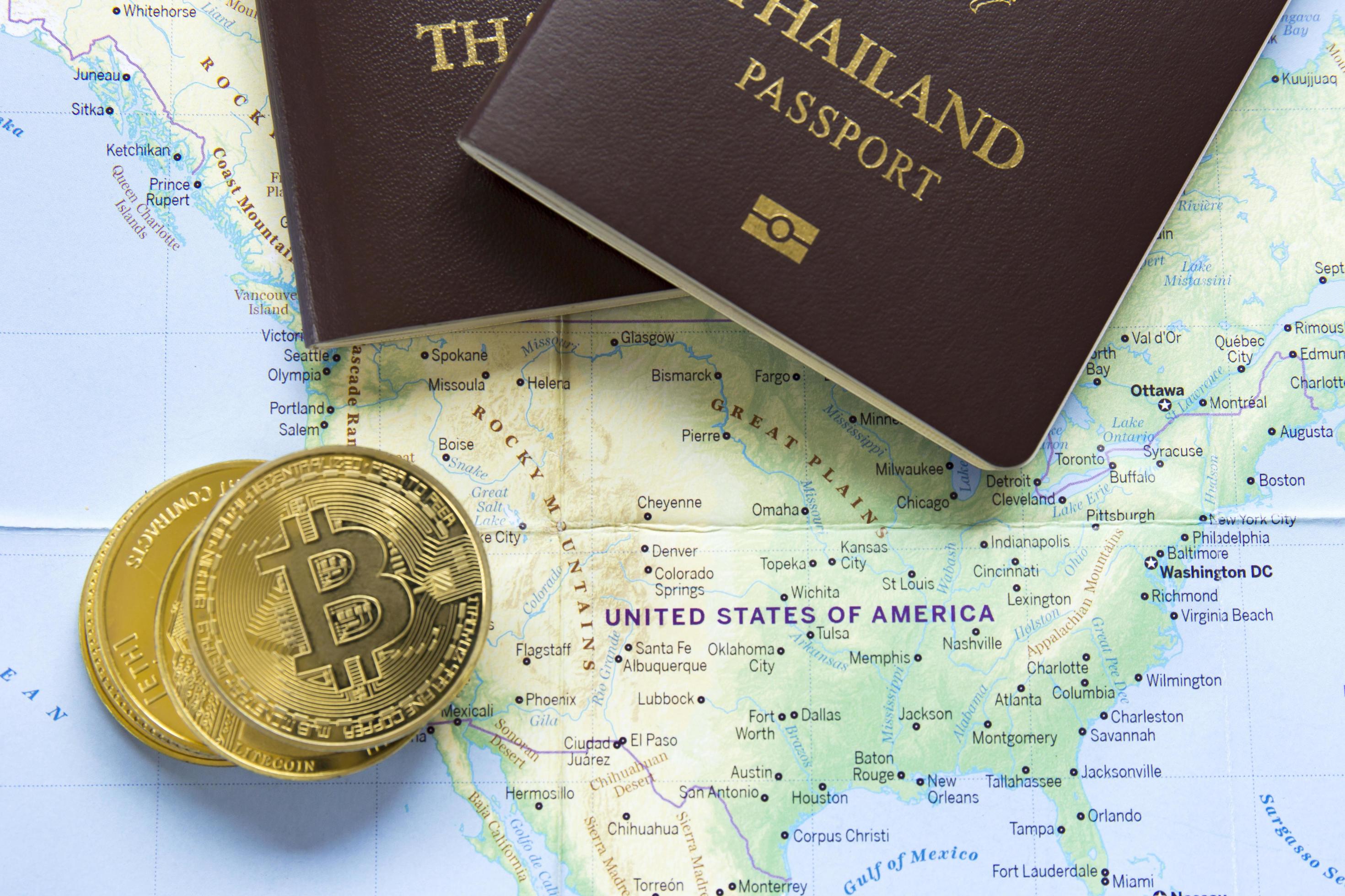 The golden bitcoins and passports were placed on the world map. 6969868