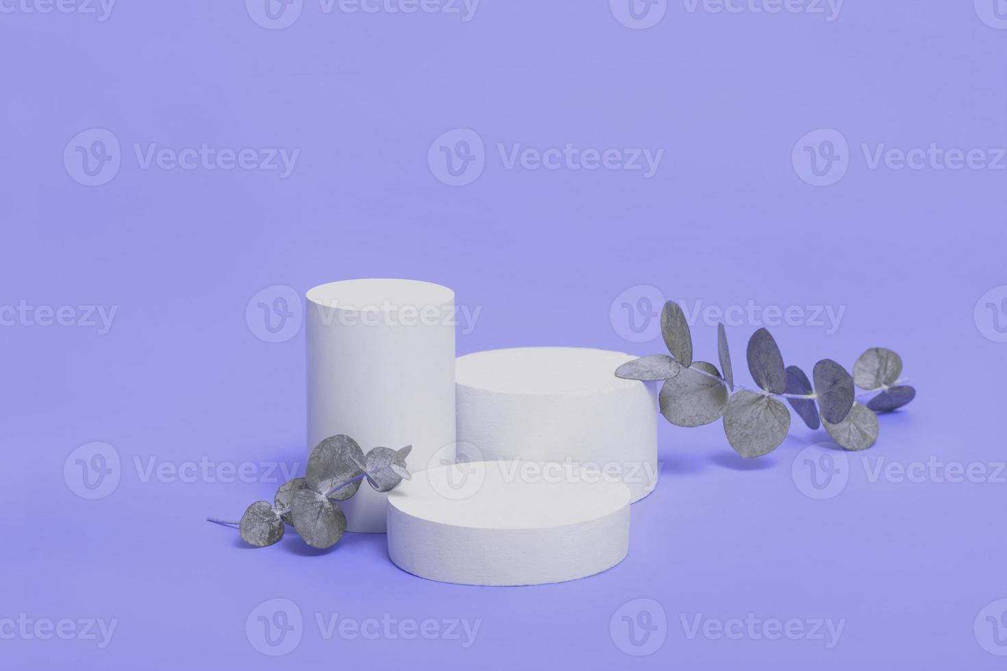 Empty concrete podium oe pedestal mock up for cosmetics with eucalyptus branch on very peri trendy color background photo