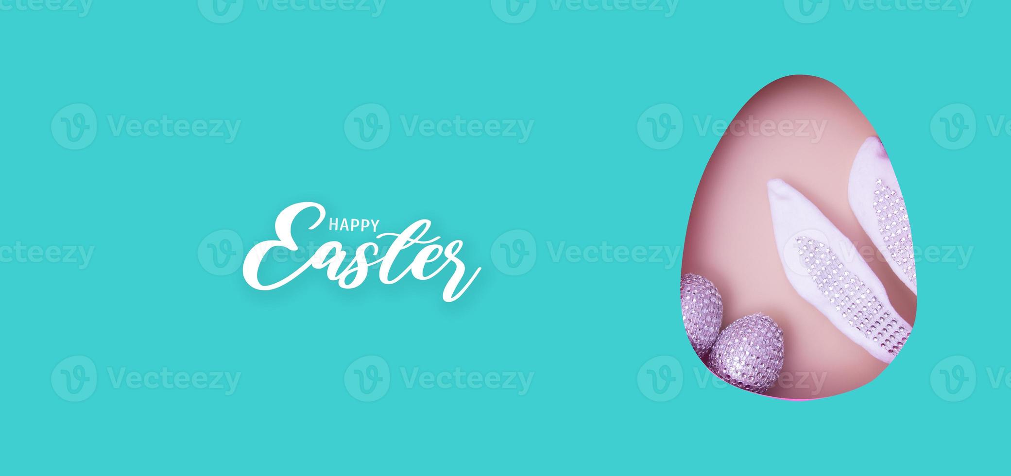 Happy Easter text with Easter egg cut out of paper and chocolate mini eggs. Creative Easter holiday greeting card banner format photo