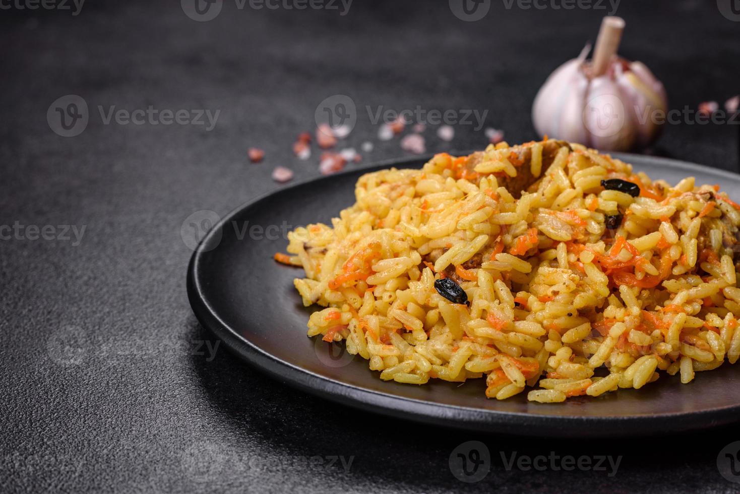 Pilaf or pilau with chicken, traditional uzbek hot dish of boiled rice, chicken meat, vegetables and spices photo