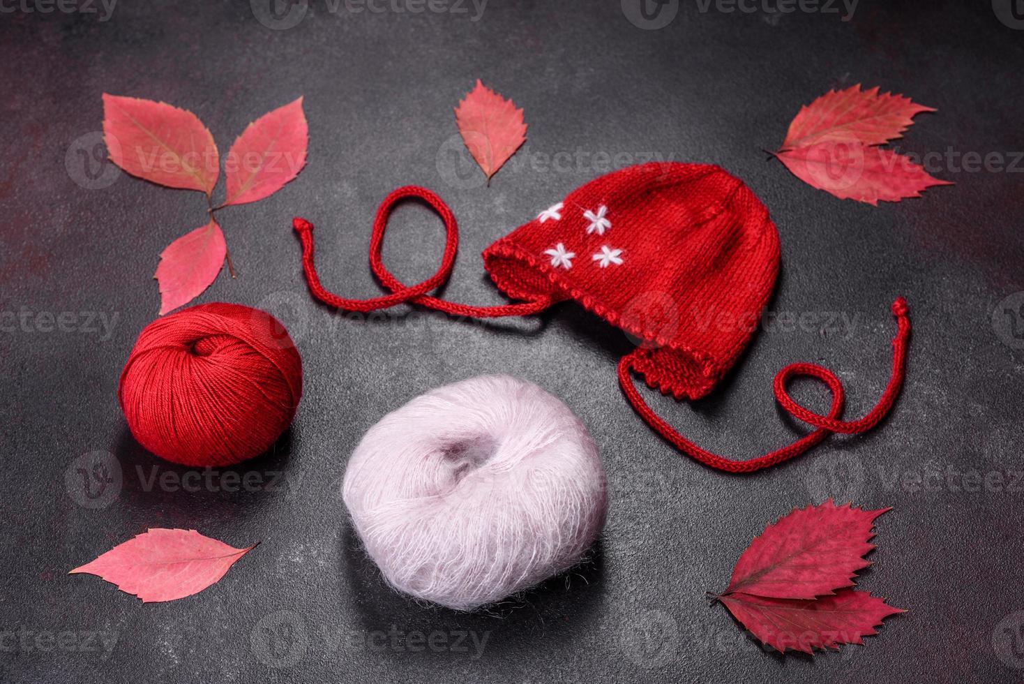 Clothing for a newborn baby knitted from red threads photo