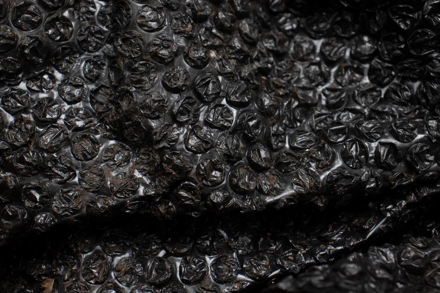 the surface of the used foam plastic that has been dirty is black photo