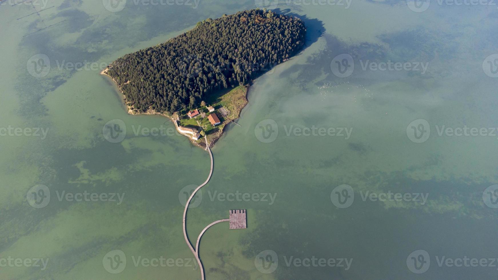 Aerial drone view of a beautiful semi island in the middle of the lake. Beautiful colors in water and amazing landscape. Travel the world and find the wonders. Relax and meditate. Holidays are coming. photo