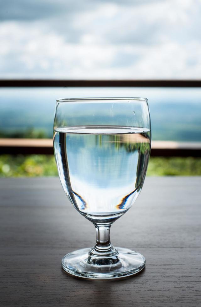 primer plano de la copa de vino llena de agua sobre la mesa. foto