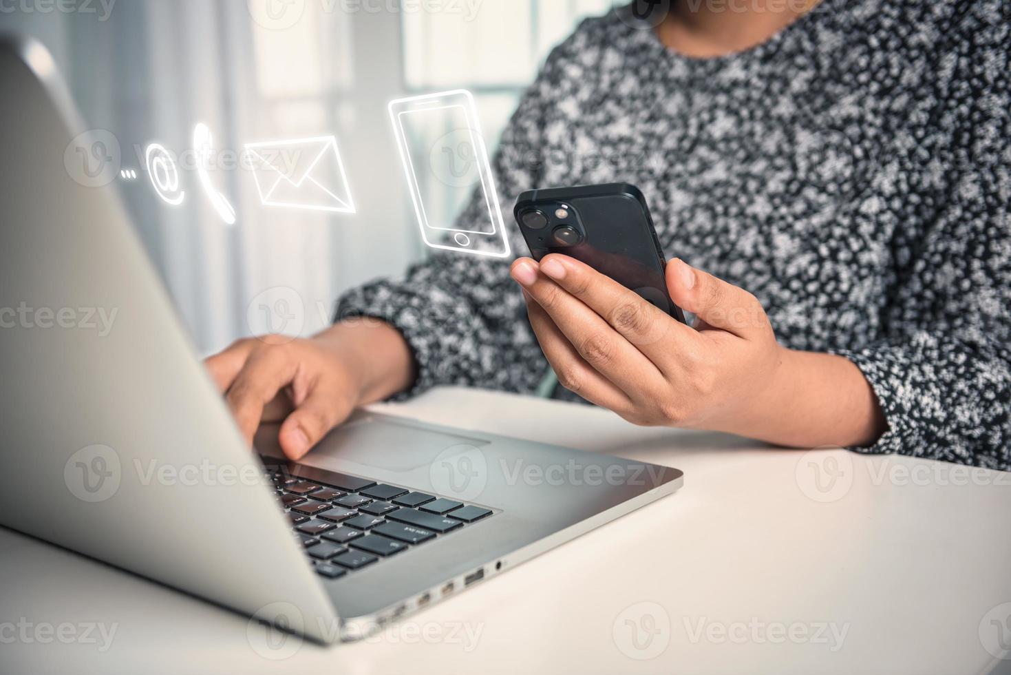Contact Us Support Service and Information Connect Concept, Female's Hands is Using Mobile Phone and Laptop for Corporate Information Contact Via Email Support. Customer Communication Contact Services photo