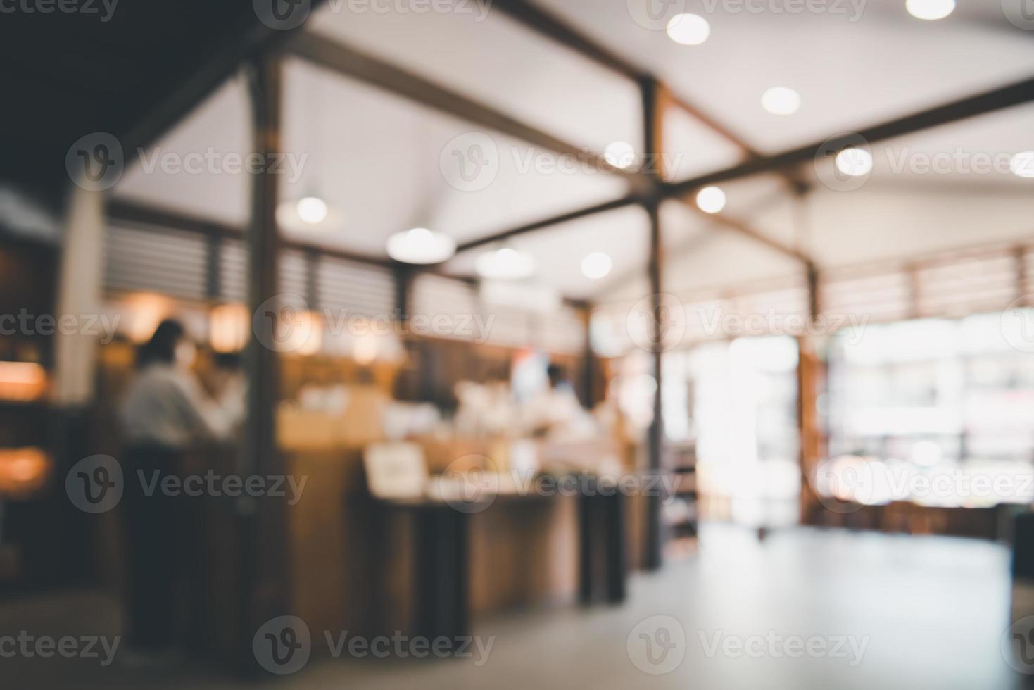 fondo de la cafetería, desenfoque abstracto desenfocado de la cafetería interior y el restaurante. espacio de bar interior de café para que el cliente se relaje. bombilla de luz bokeh borrosa en la tienda de café foto