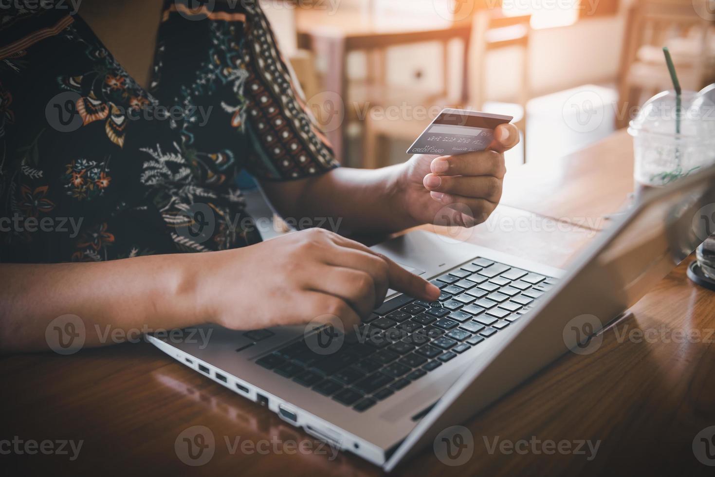 Business Credit Banking and Online Shopping Service, Close-Up of Business Woman Hands Using Credit Card for Paying Online Shopping on E-Commerce Web in Coffee Shop. Shopping Payment Via Credit Card photo