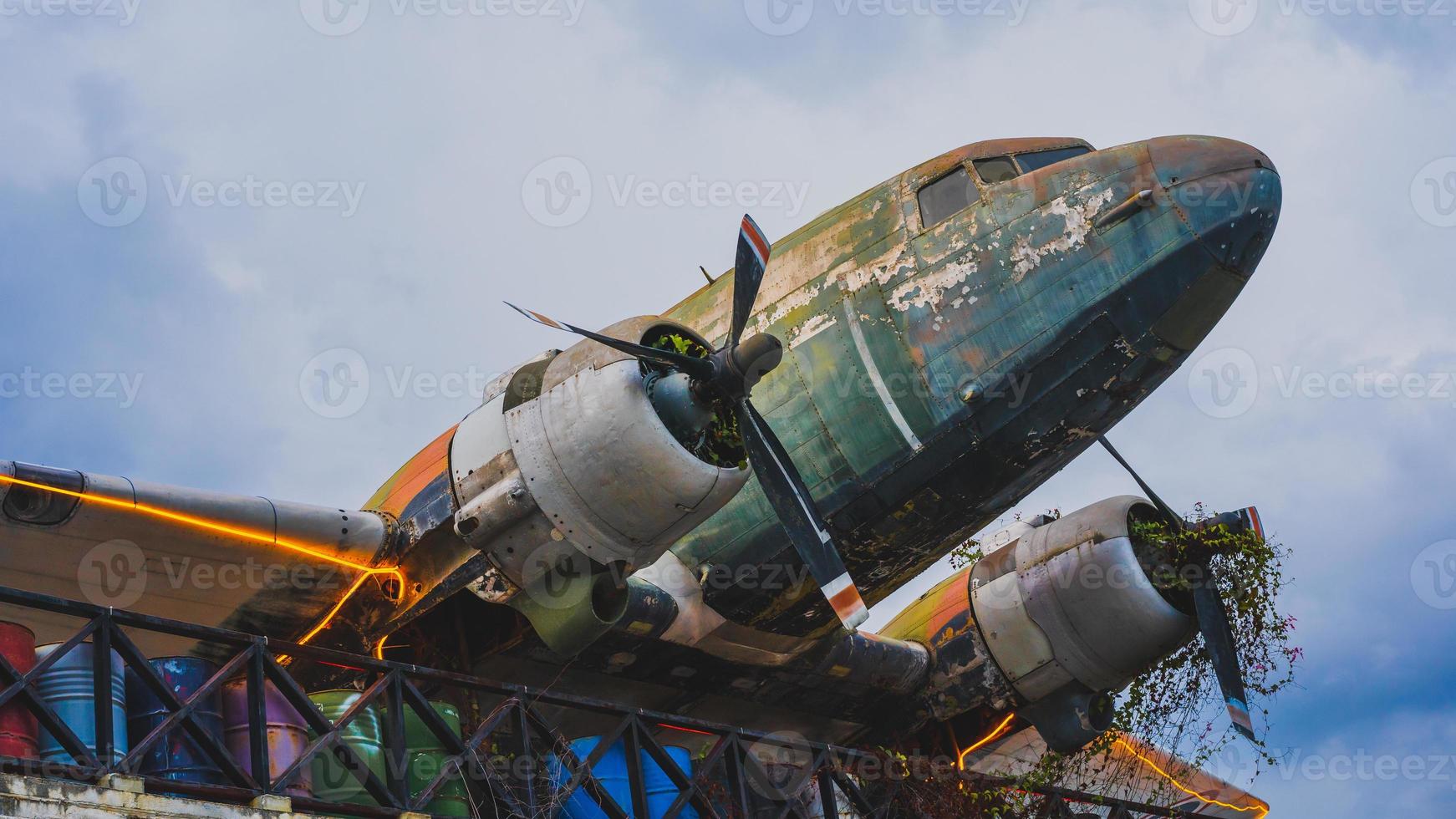 An old plane decorated with branches and lights. photo