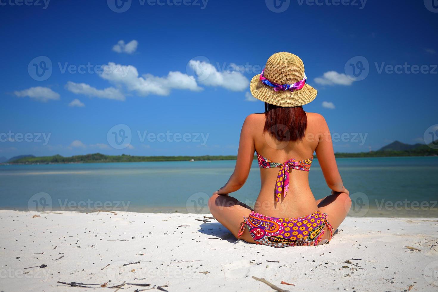 Free action and relaxing of bikini tanned girl on white sand beach at Krabi, Thailand. Concept image for summer vacation in tropical country. photo