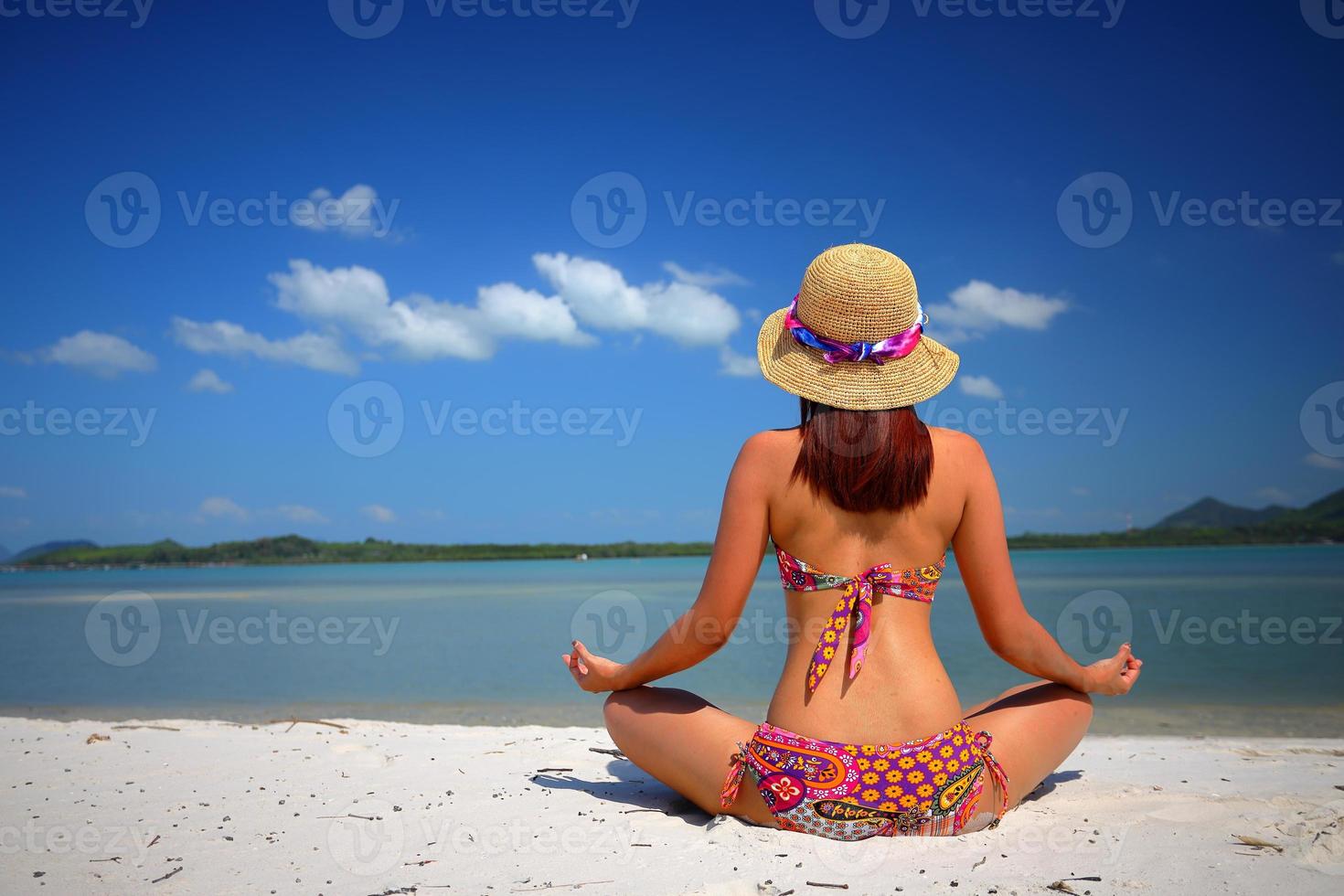 Free action and relaxing of bikini tanned girl on white sand beach at Krabi, Thailand. Concept image for summer vacation in tropical country. photo
