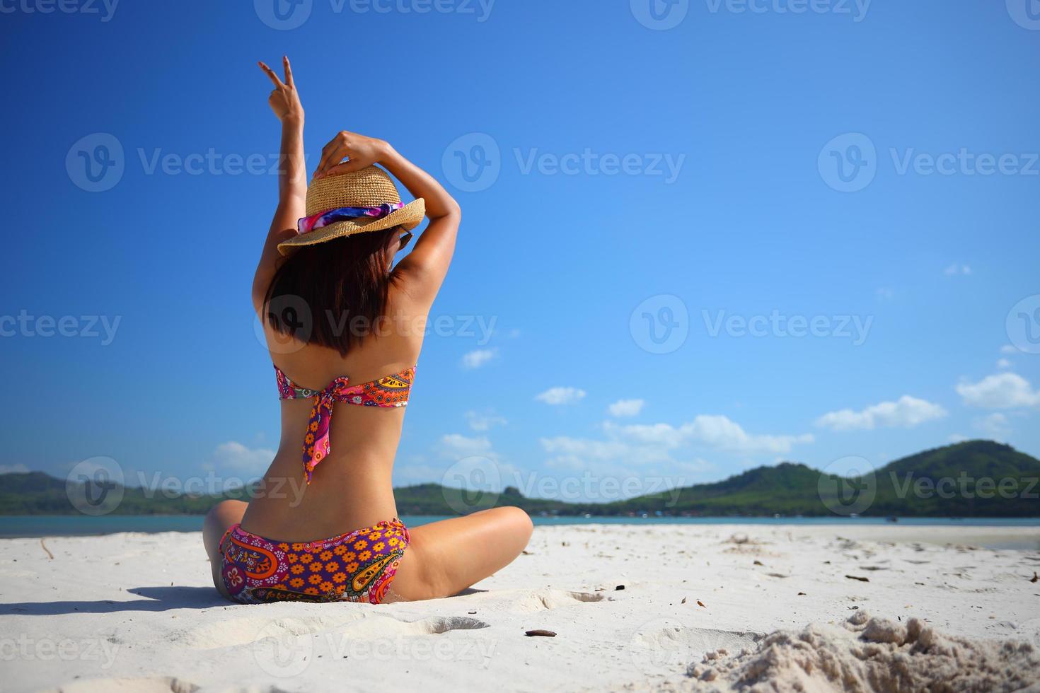 Free action and relaxing of bikini tanned girl on white sand beach at Krabi, Thailand. Concept image for summer vacation in tropical country. photo