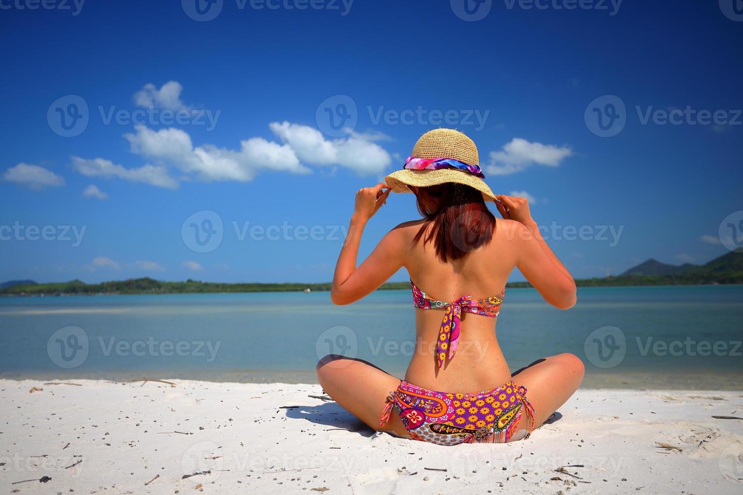 Free action and relaxing of bikini tanned girl on white sand beach at Krabi, Thailand. Concept image for summer vacation in tropical country. photo