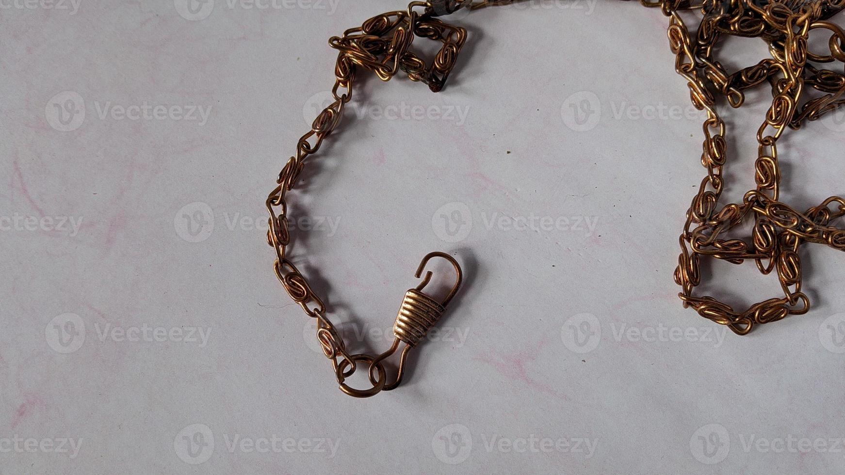 Gold colored chain which is usually used for bag straps. photo