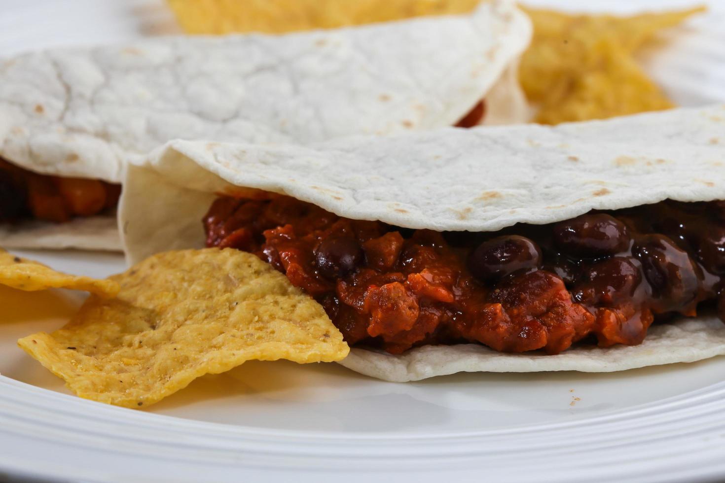 Tortilla with beans and corn chips detail photo