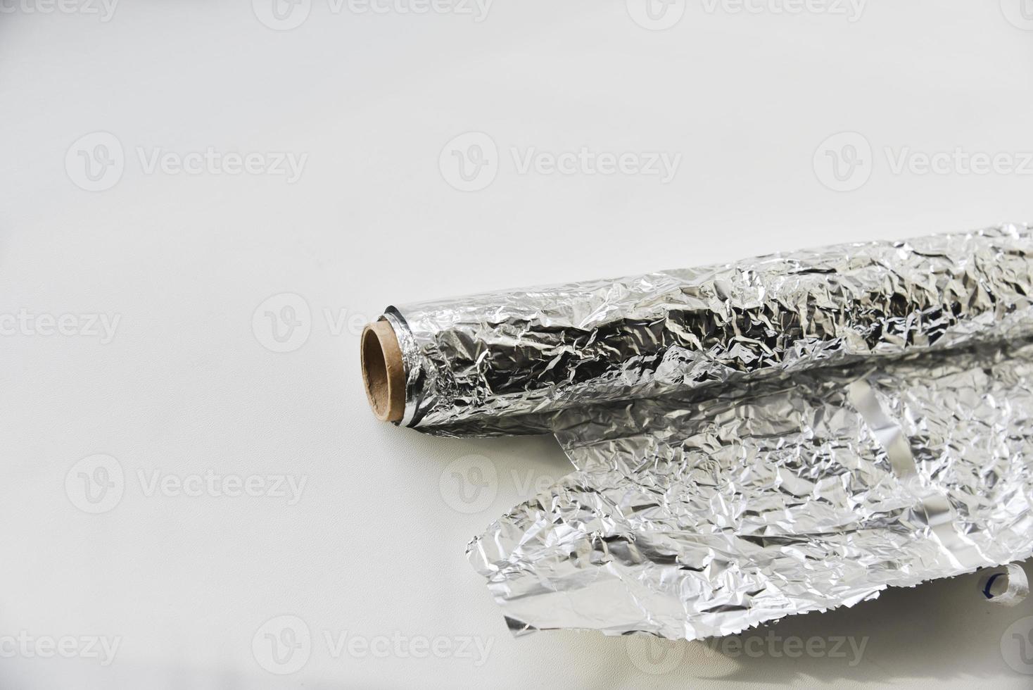 Aluminum foil roll on white background photo