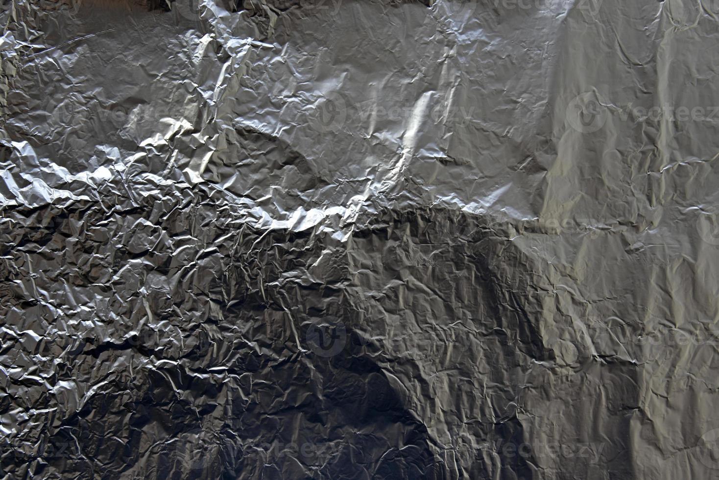 Silver background of crumpled aluminum foil photo