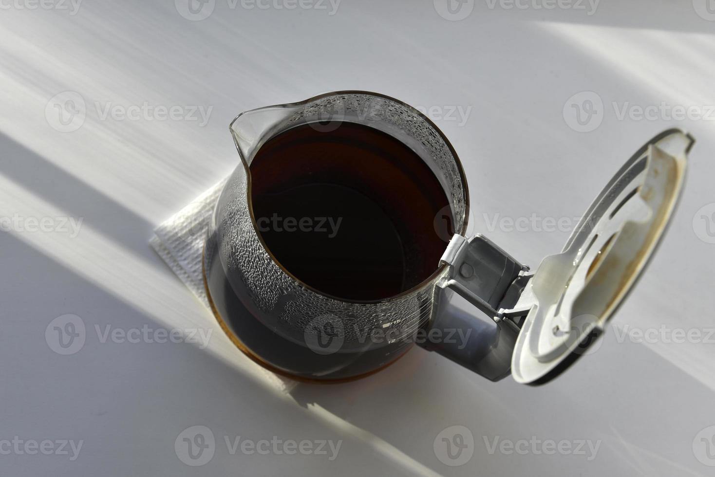 Glass coffee jug with a drink on a white background photo
