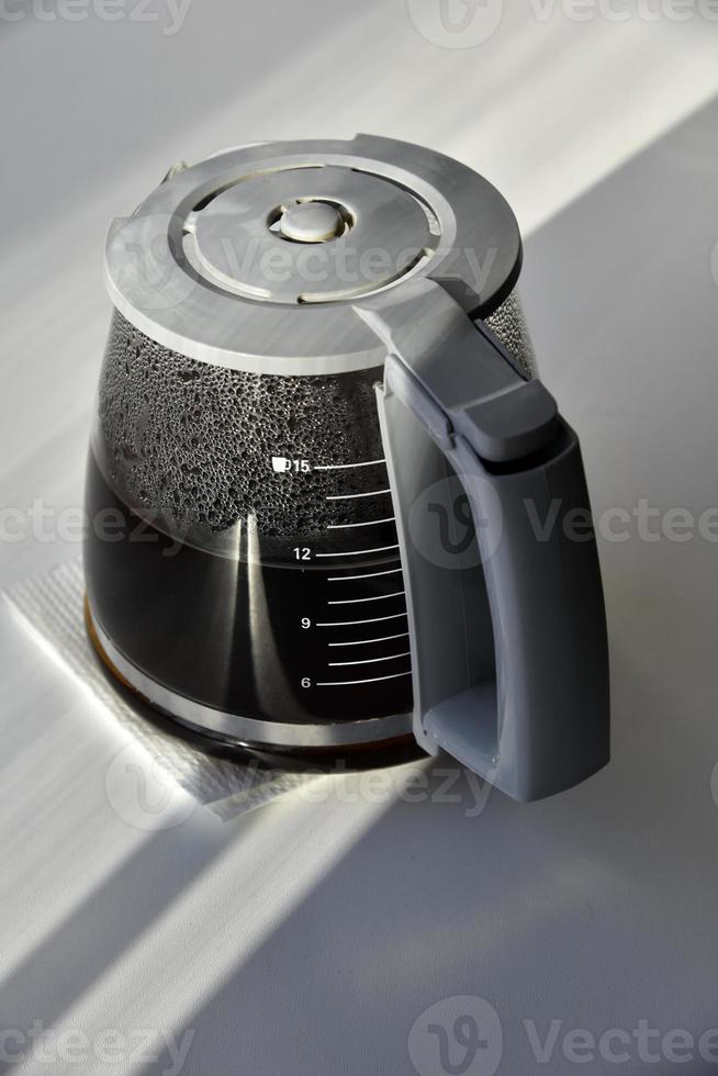 Glass coffee jug with a drink on a white background photo