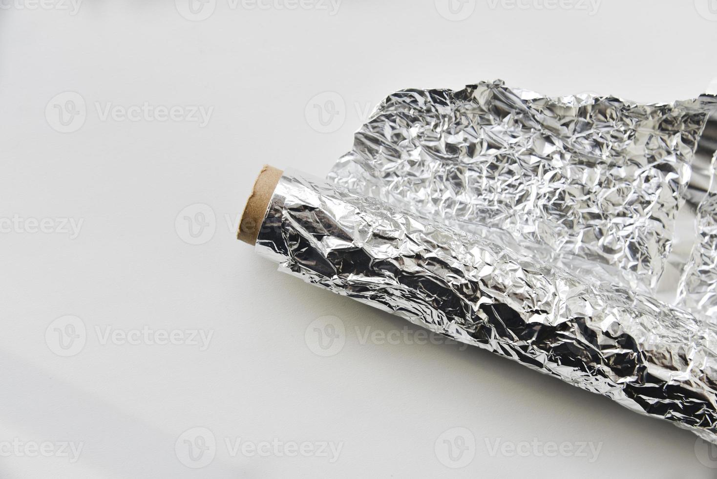 Aluminum foil roll on white background photo