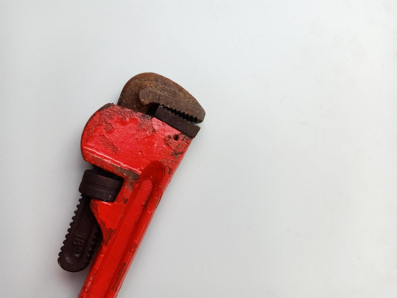 Rusty pipe wrench isolated on white background, photo concept for plumbing tools and equipment
