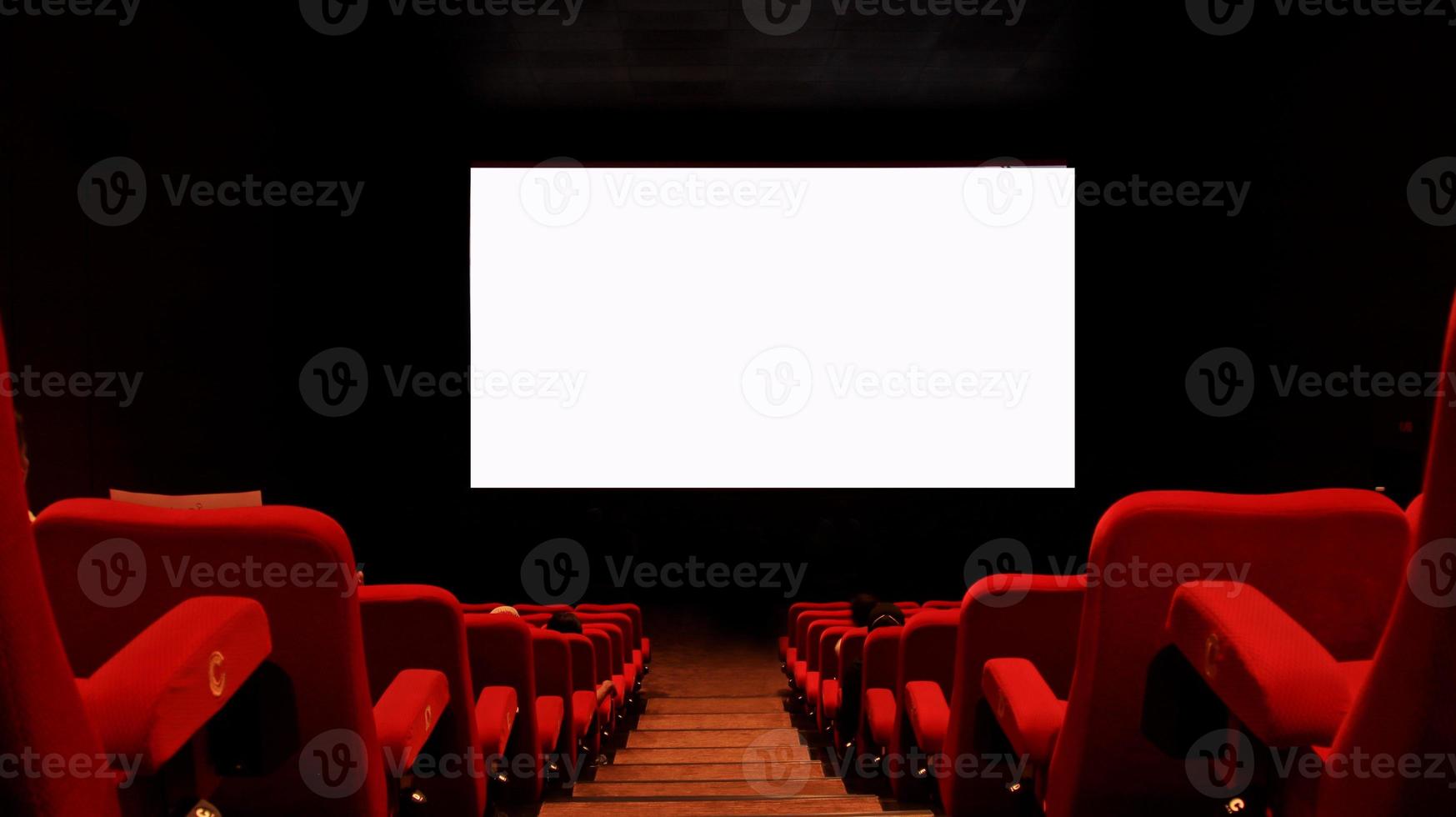Empty cinema auditorium with empty white screen. photo