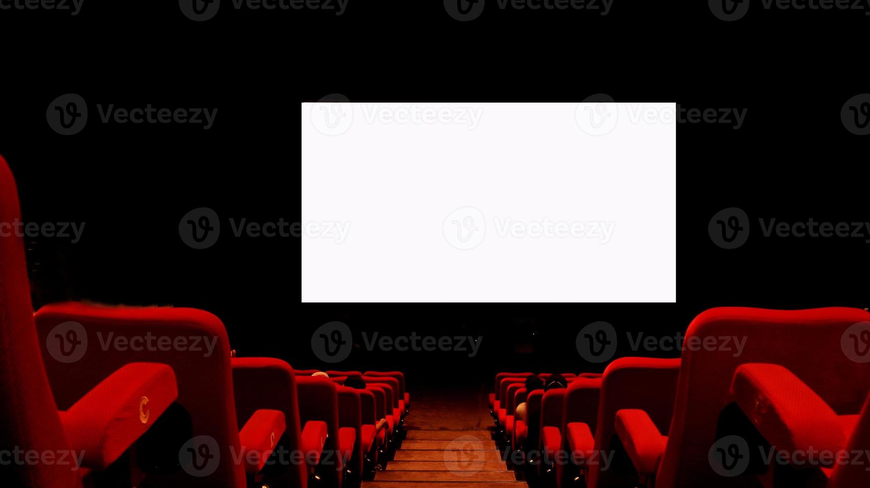 Empty cinema auditorium with empty white screen. photo