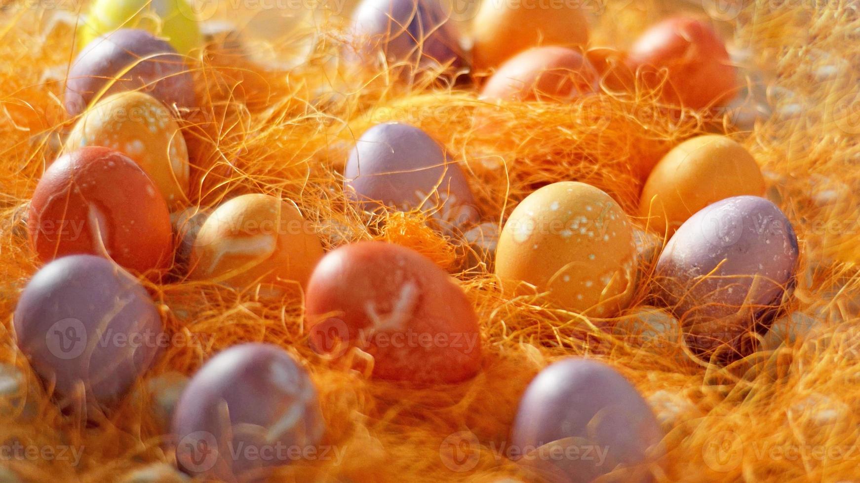 Mulicoloured Painted Easter eggs in decorative mesh.Easter background. photo