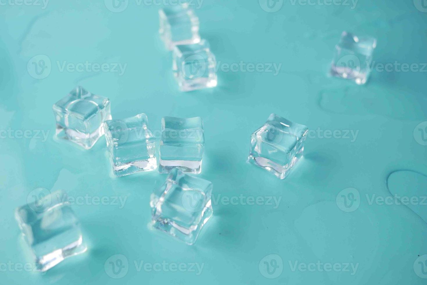 top view of many ice cubes on light green background.. photo