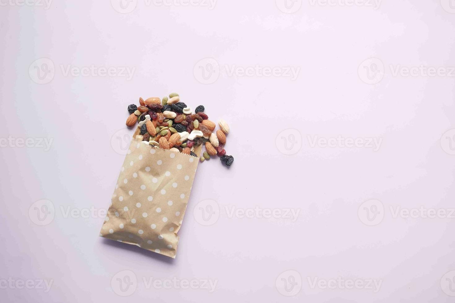 top view of many mixed nuts spilling a from a packet photo