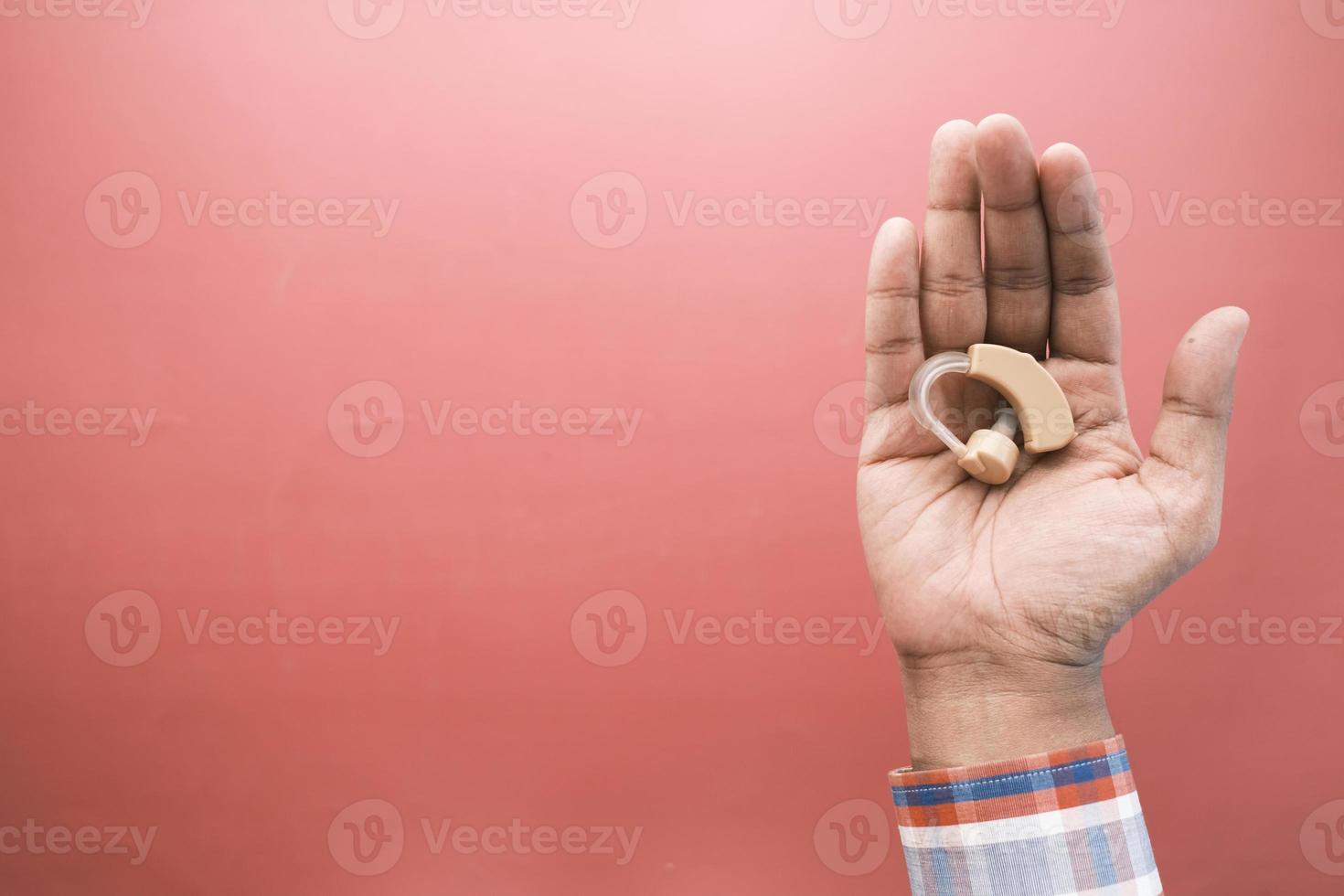 Hearing aid concept, a young man with hearing problems. photo