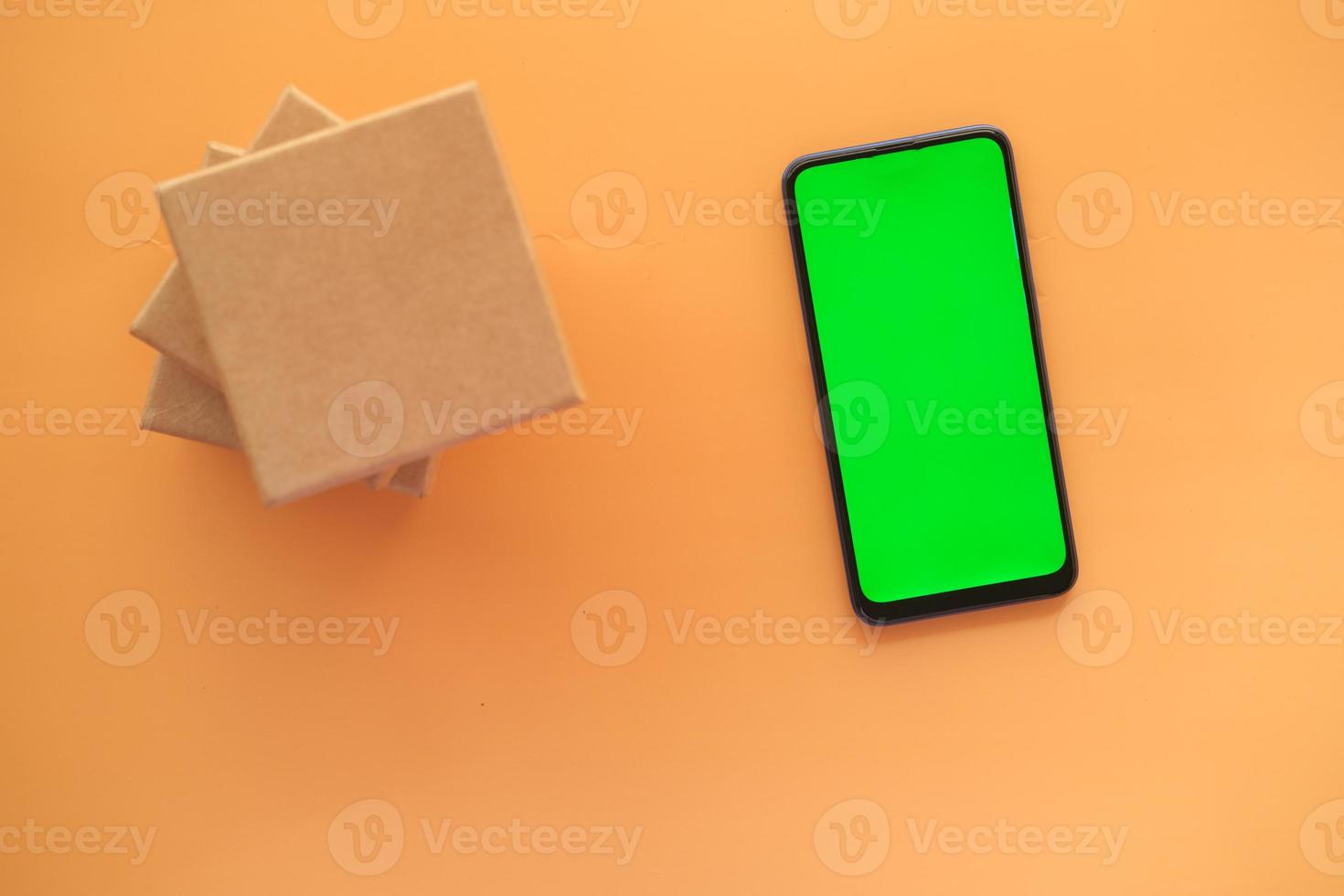 stack of gift box and smart phone on table photo