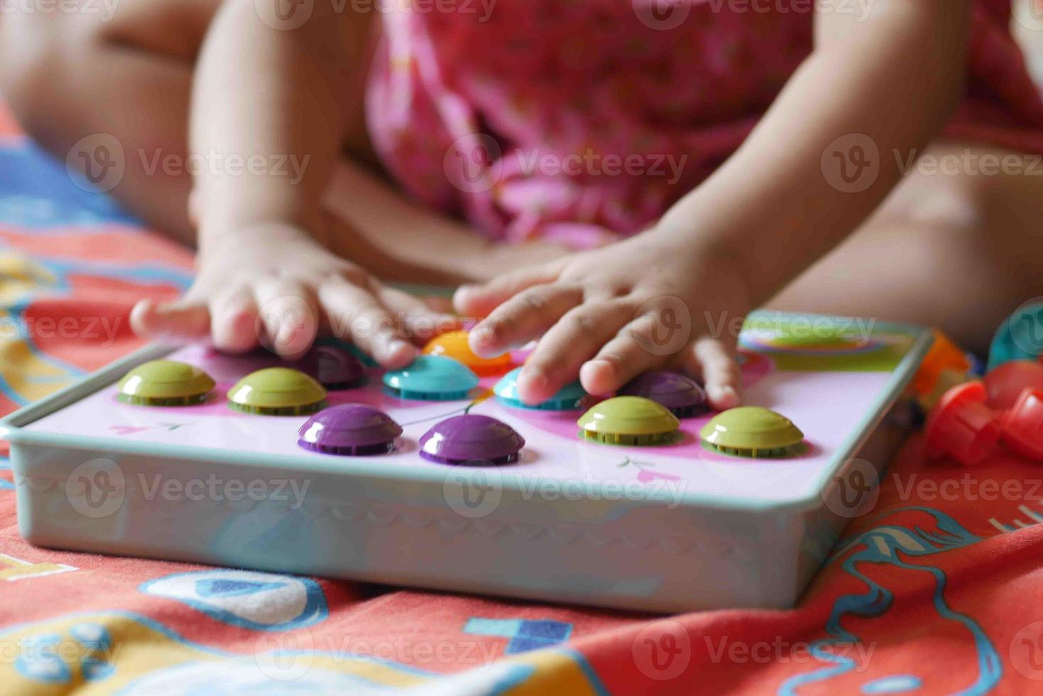 toddler playing with counting math learning toy . photo