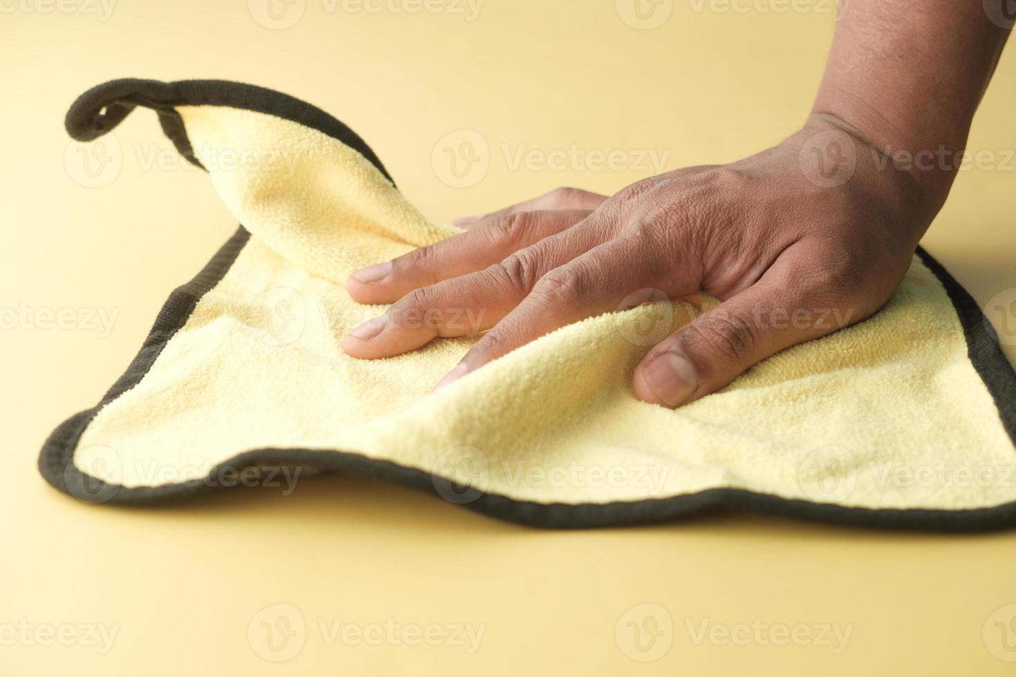 close up of person hand cleaning table with cloth photo