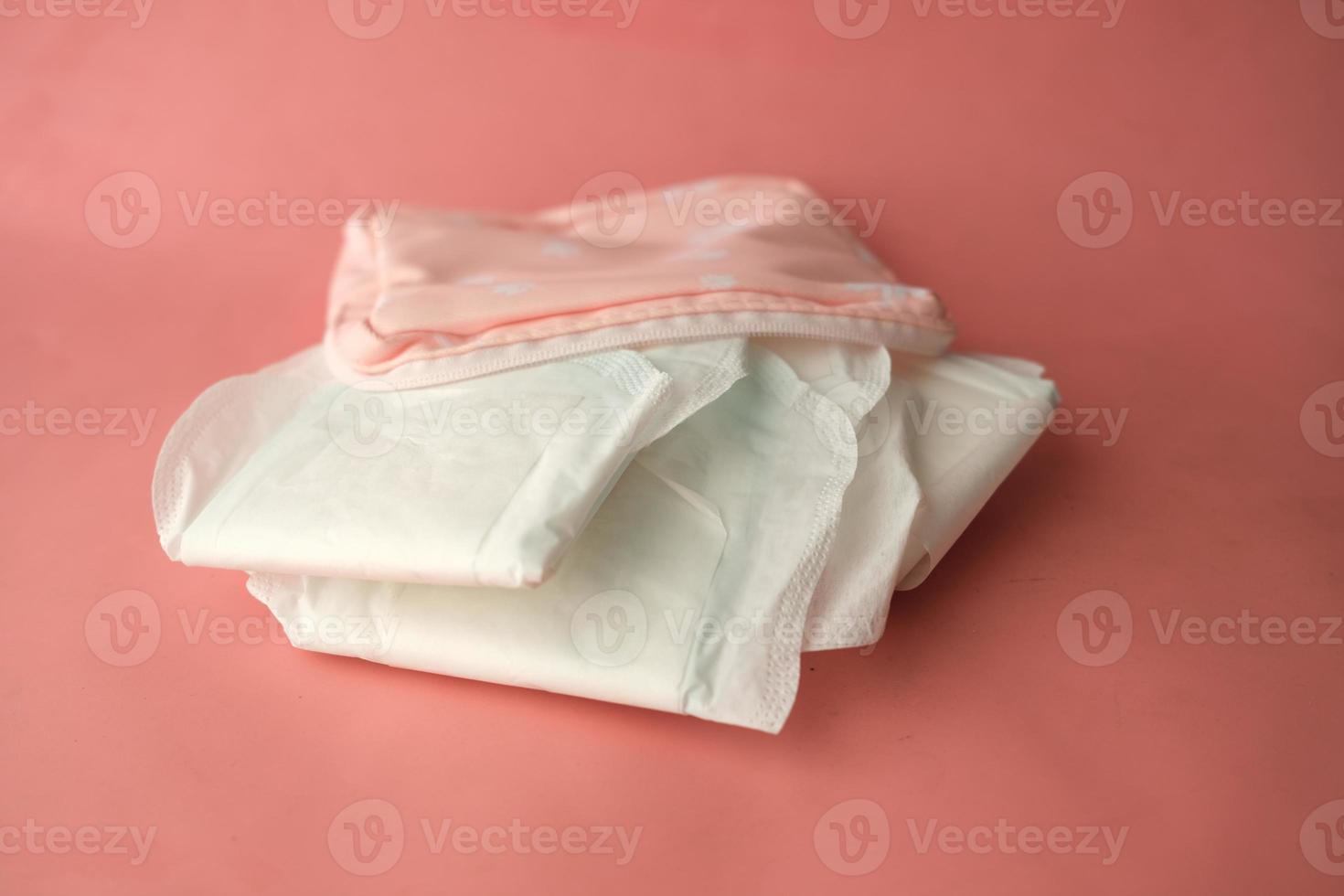 close up of sanitary pad on a pink background photo