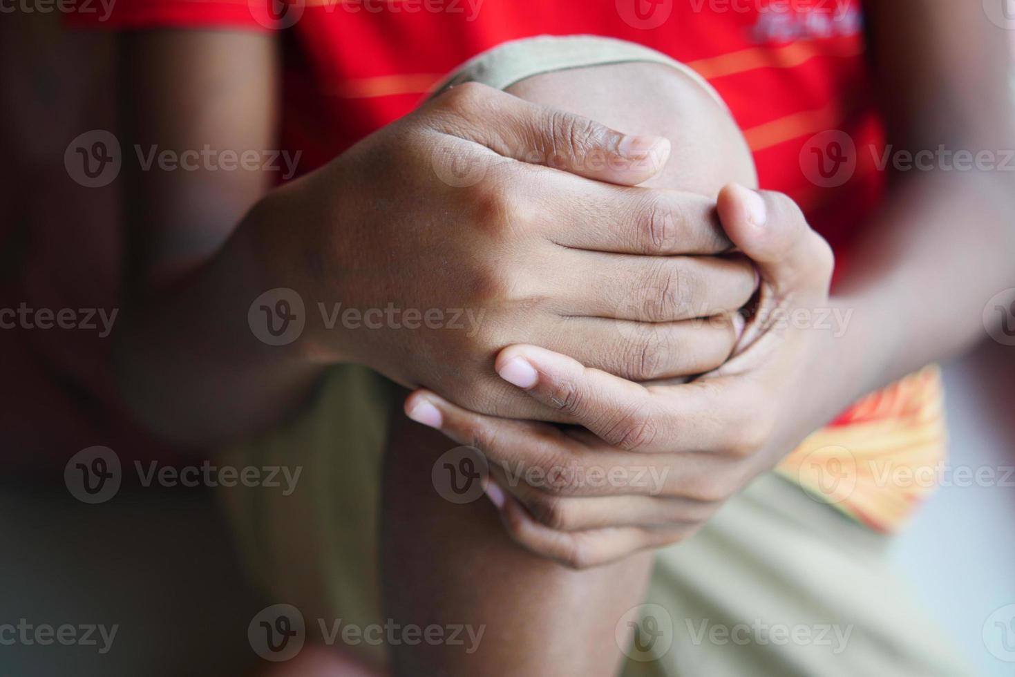 Close up on man suffering knee joint pain photo