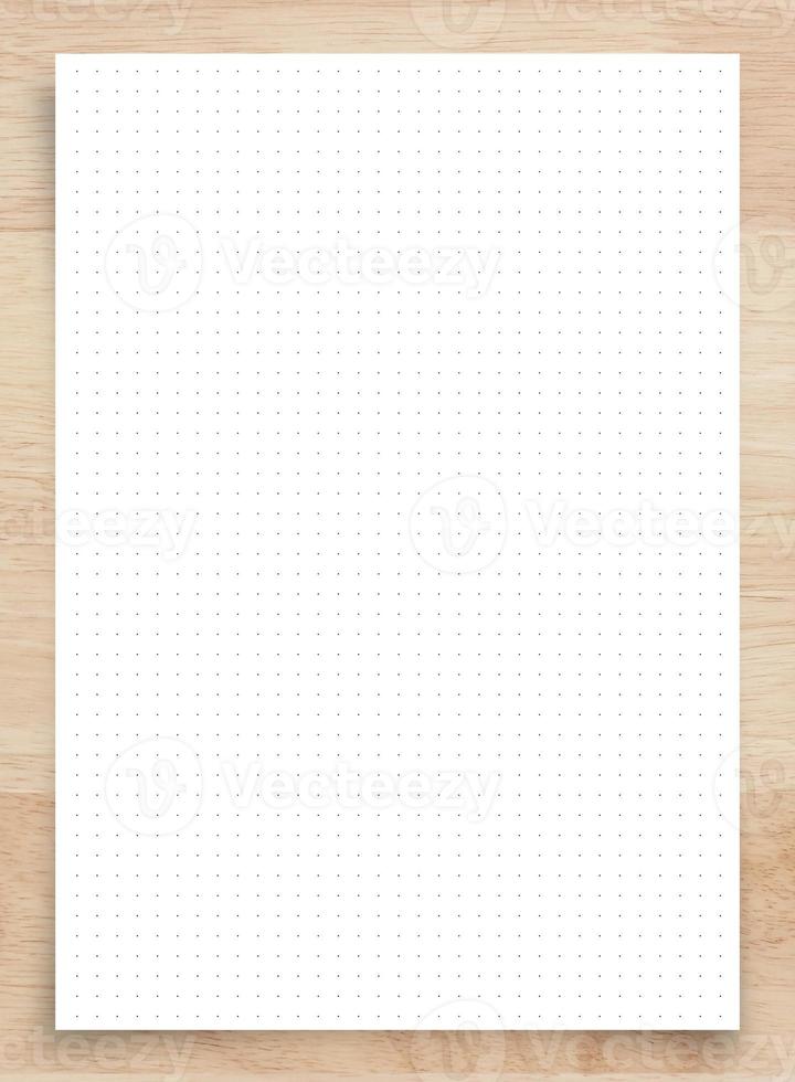 White paper with grid line pattern on wood, use for background. photo