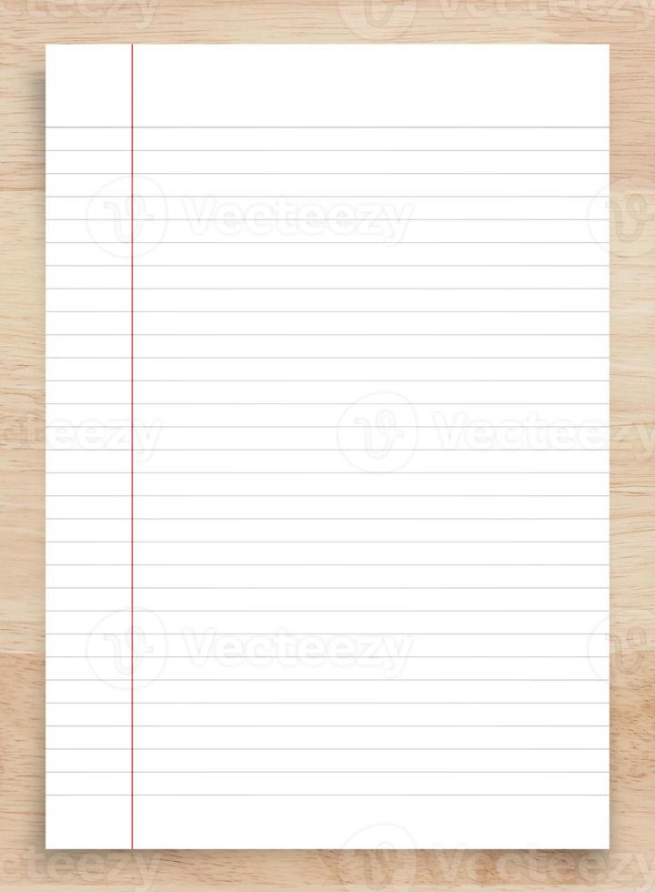 White paper sheet on wood with clipping path. White notebook paper for background. photo