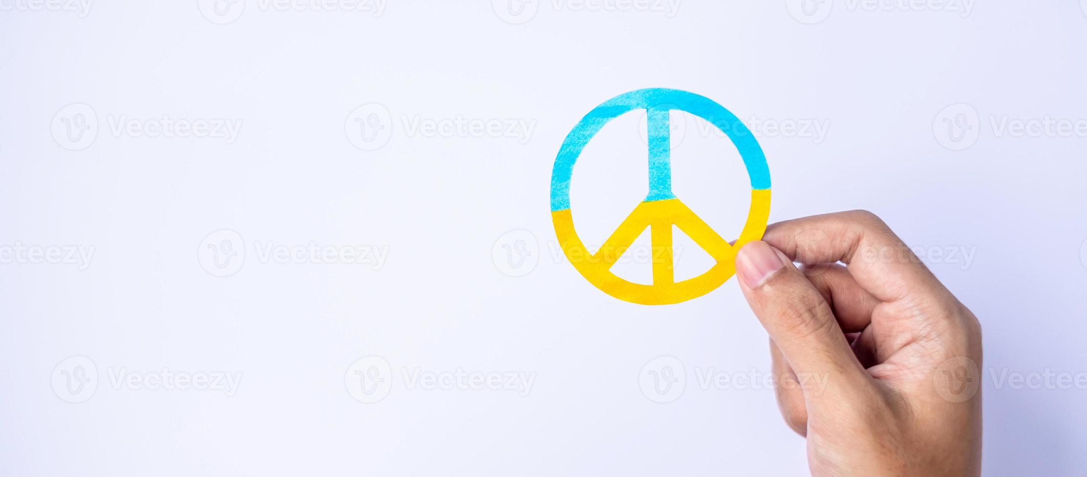 Support for Ukraine in the war with Russia, Hands holding symbol of peace with flag of Ukraine. Pray, No war, stop war, stand with Ukraine and Nuclear Disarmament photo