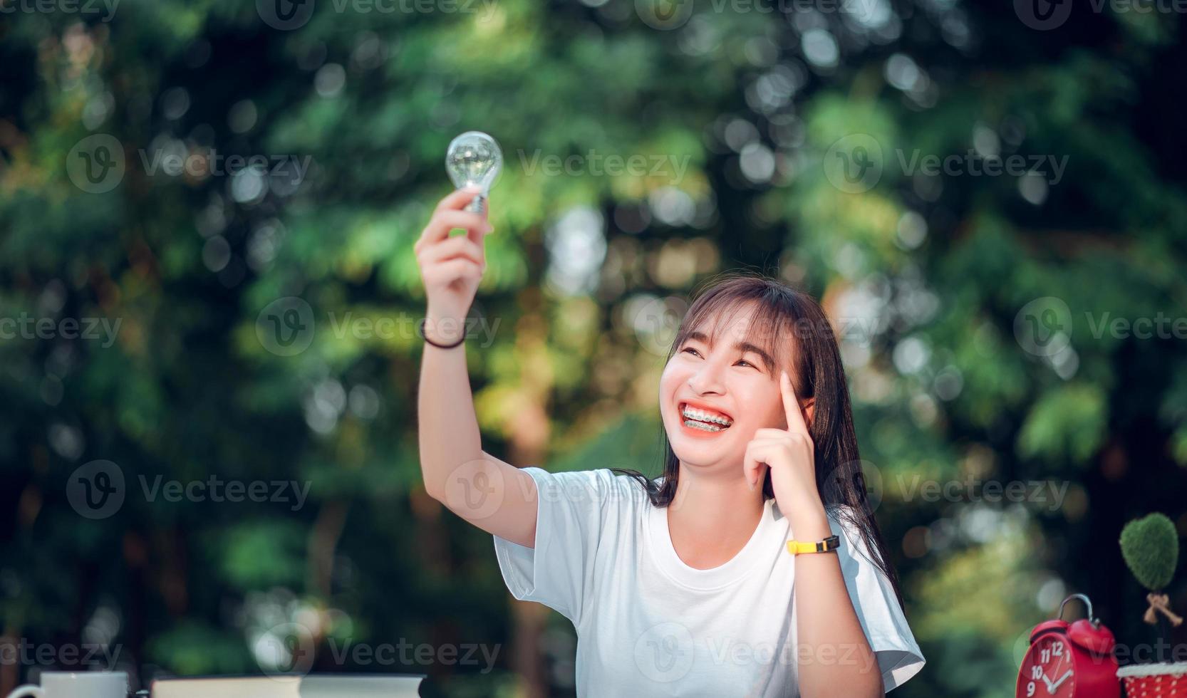 technology ideas beautiful girl designer Touch the light bulb . Concept of Ideas to present new ideas. Great inspiration and innovation to start over. photo