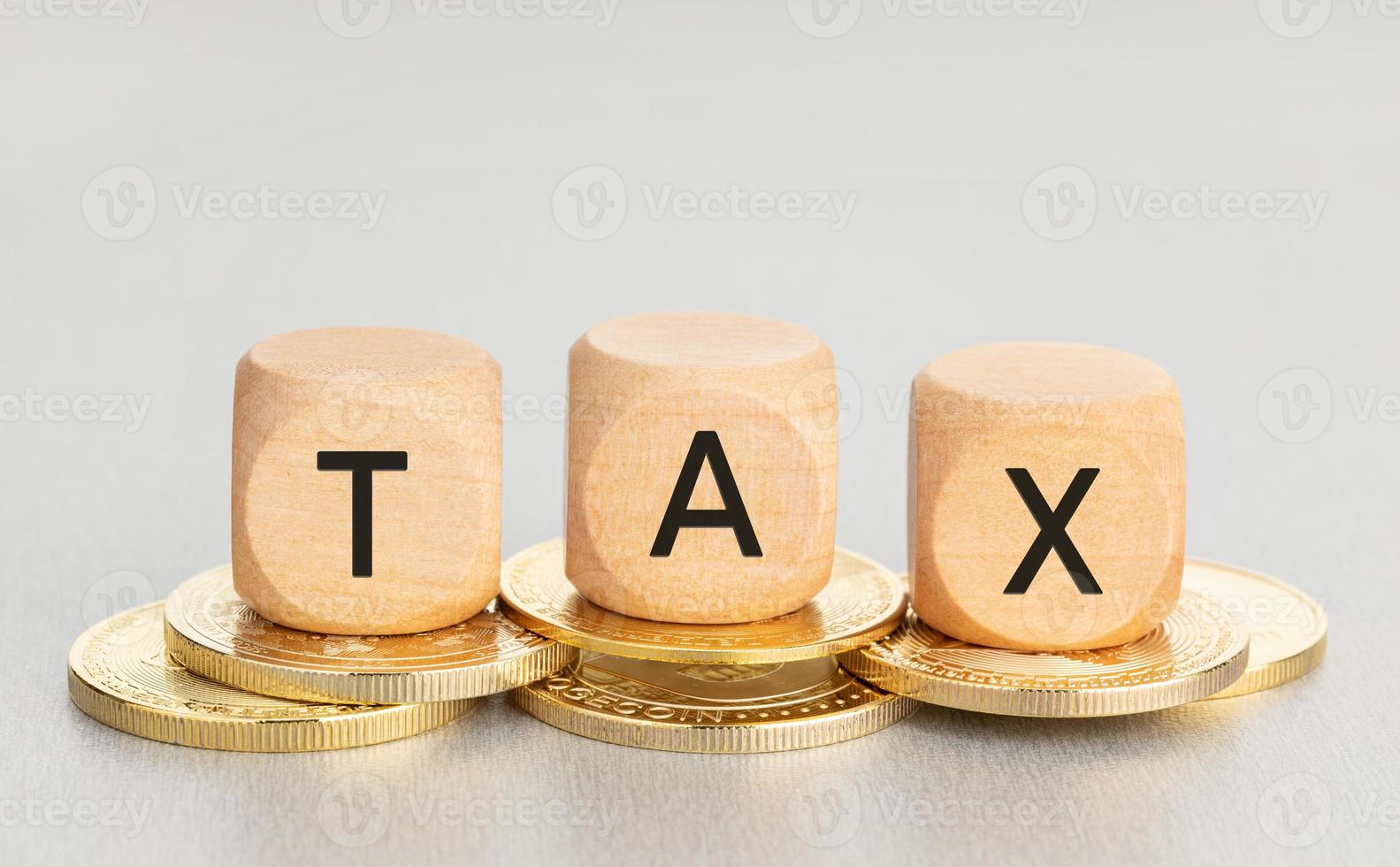 Cryptocurrency TAX concept. Coins and wooden blocks with text. Copy space photo