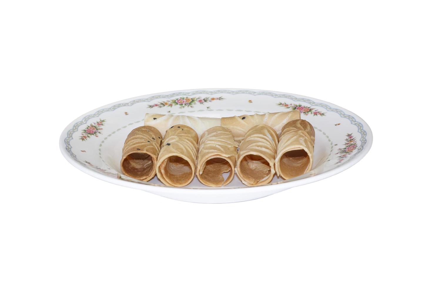 Tong Muan Rolled Wafer Thailand at the dish on white background. photo