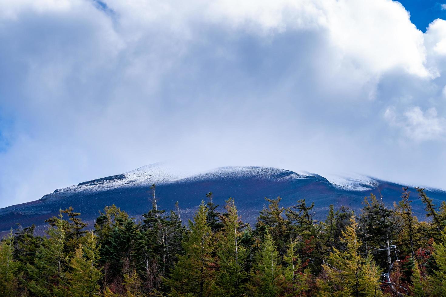 Close up top of Fuji mountain with snow cover and wind on the top with could in Japan. photo