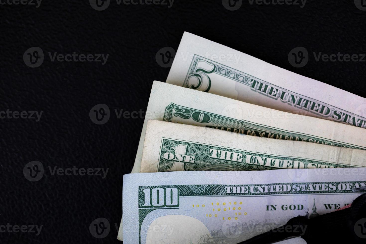 US Dollars on black background. photo