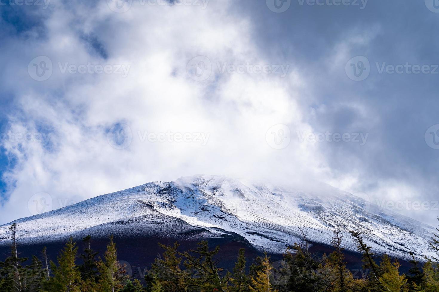 Close up top of Fuji mountain with snow cover and wind on the top with could in Japan. photo